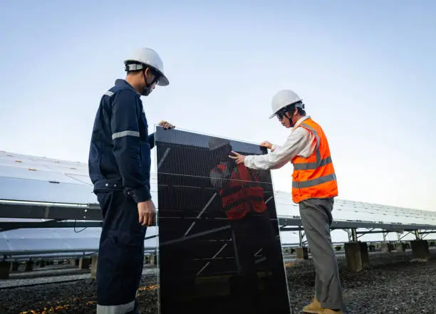 Technician is lifting the solar cell to replace the damaged one, Alternative energy to conserve the world's energy, Photovoltaic module idea for clean energy production.