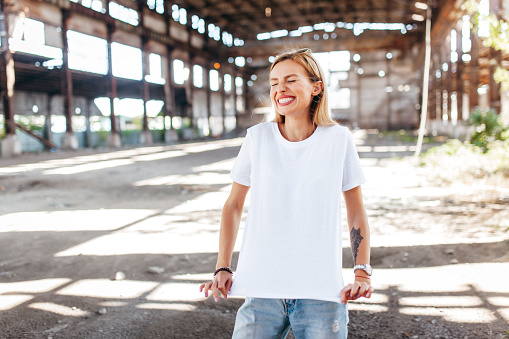 Stylish blonde girl wearing white t-shirt and glasses