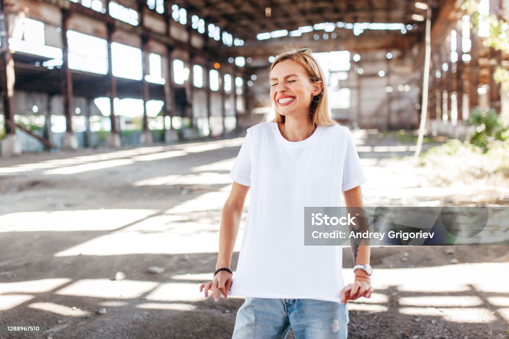 Stylish blonde girl wearing white t-shirt and glasses T-Shirt Stock Photo