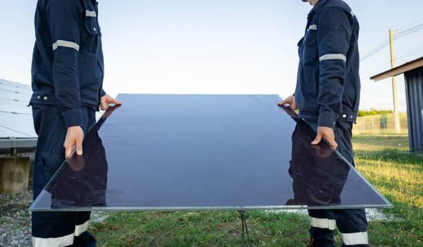 Technician is lifting the solar cell to replace the damaged one, Alternative energy to conserve the world's energy, Photovoltaic module idea for clean energy production