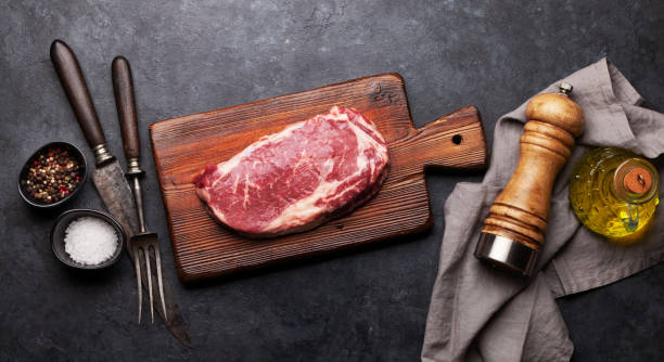 istock Raw beef ribeye steak on cutting board 1288968532
