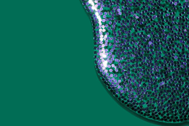 istock pouring purple glitter liquid on a tidewater green background 1288970949