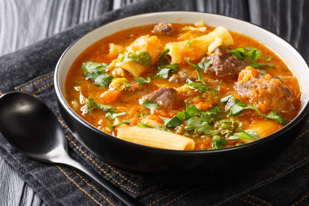 soup joumou or haitian beef and pumpkin soup is a famous mildly spicy soup prepared with beef and vegetables and also rigatoni pasta closeup in the plate. horizontal - portion pumpkin vegetable black imagens e fotografias de stock