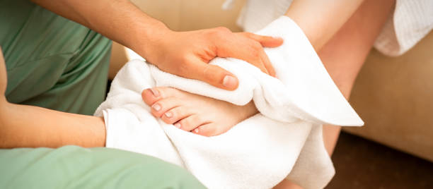 istock Masseur wiping the woman's legs 1288971832