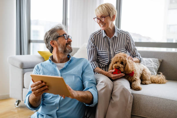 istock Happy smiling mature couple using digital tablet at home 1288972051