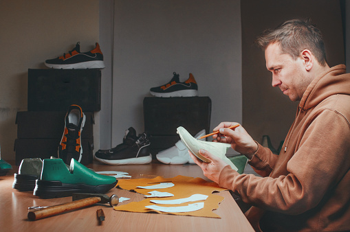 Shoemaker Drawing A Pattern On The Shoe Model Stock Photo - Download ...