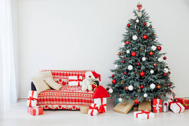 istock Red decor new year interior Christmas tree with gifts 1288972649