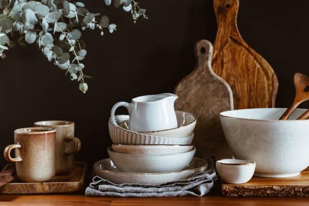 istock Set of kitchen ceramic tableware and wooden cutting boards on a table. Eco style home still life. 1288973181