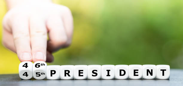 Hand turns dice and changes the expression "45th president" to "46th president". Hand turns dice and changes the expression "45th president" to "46th president". inauguration into office photos stock pictures, royalty-free photos & images