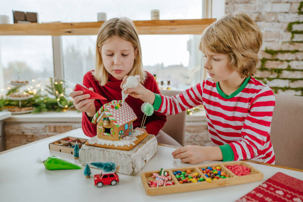 istock Children decorated Christmas gingerbread house on the table 1288973569
