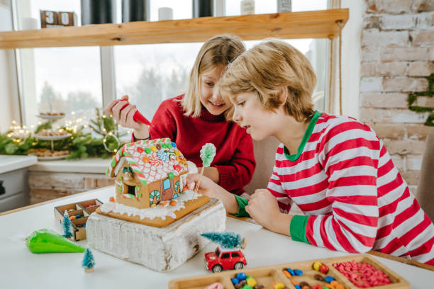 istock Children decorated Christmas gingerbread house on the table 1288973600