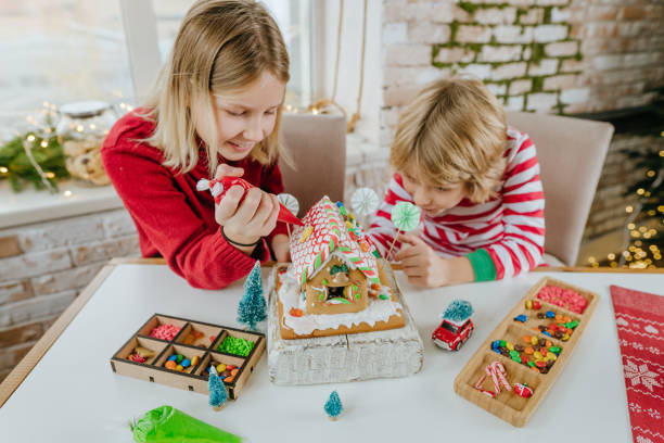 istock Children decorated Christmas gingerbread house on the table 1288973612