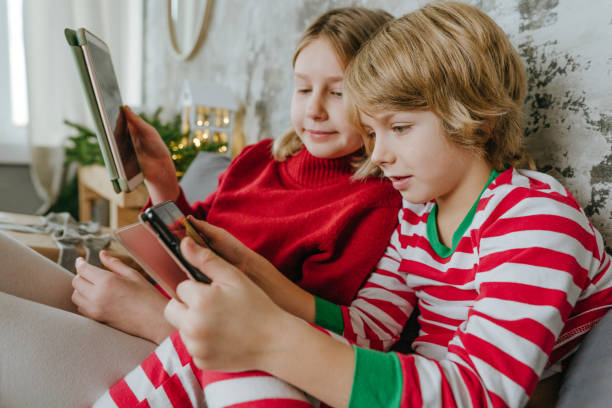 istock Boy and girl using tablets in Christmas time 1288973780