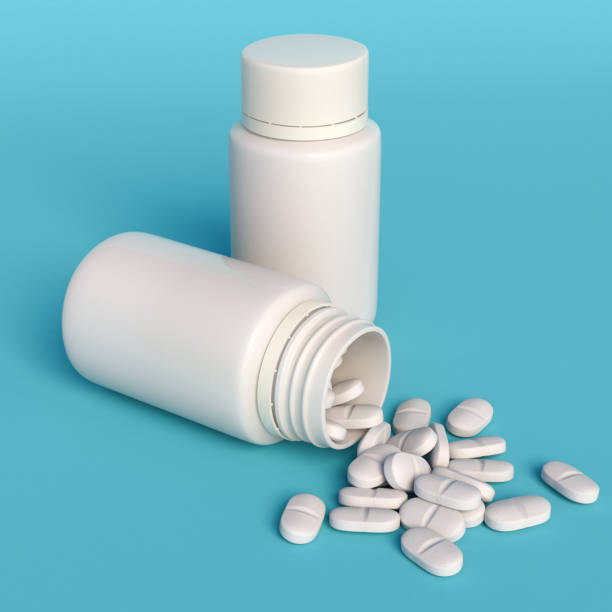 istock White medical drugs flasks on blue background. 1288974710