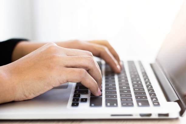istock A business woman using a laptop And has the company's performance document. 1288974766