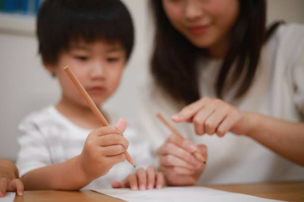 istock Parents and children practicing how to hold a pencil 1288976247