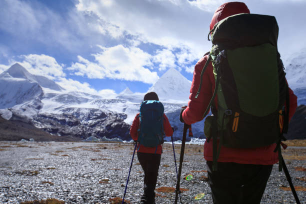 istock Two women hikers hiking  in winter mountains 1288976302