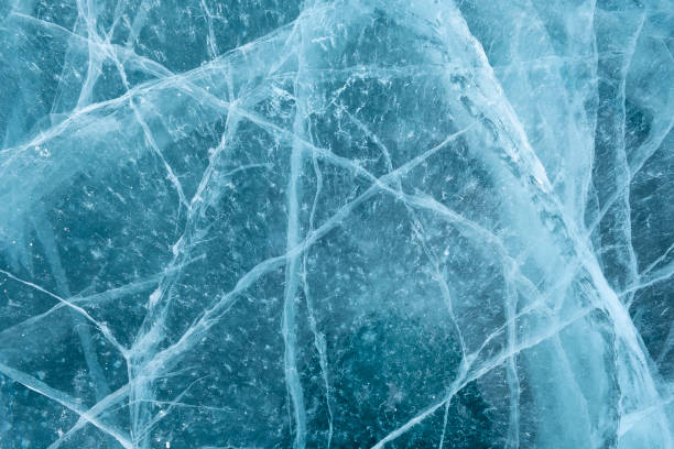 istock Cracks in the ice. Frozen lake surface. 1288976546