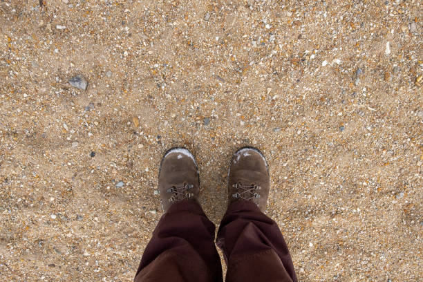 istock Man in hiking boots on a coarse sand. 1288976576