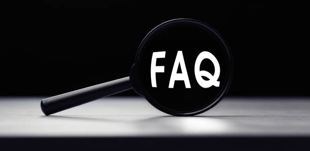 istock Magnifying glass with the word FAQ - Frequently Asked Questions on table. Search idea 1288977610
