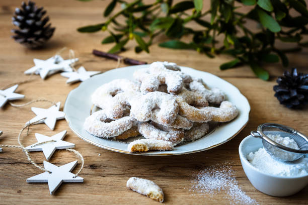 istock Christmas cookies on a plate with a mistletoe on a wood table 1288977681