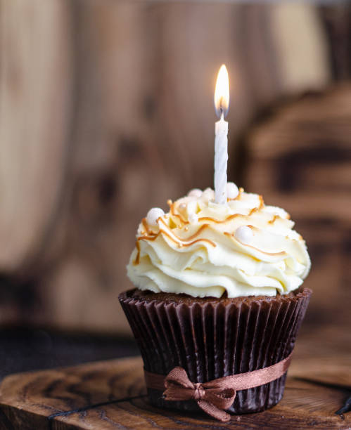 istock birthday cupcakes with caramel syrup and cream cheese. 1288978435