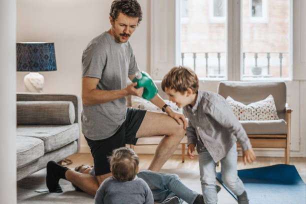 istock Father with children exercising at home 1288978841