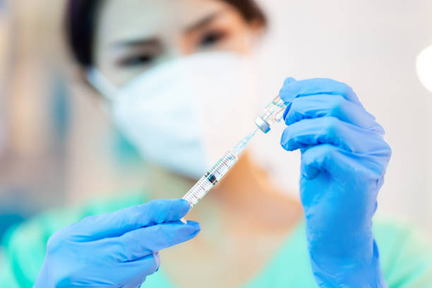 istock Nurse put vaccine into injection 1288979032