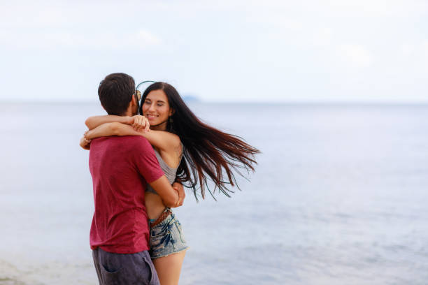 istock Happy young couple having fun at the beach . 1288979709