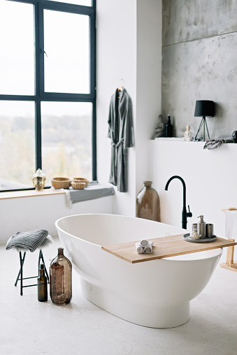 White modern bath in contemporary apartment with stylish loft style interior design, home decor. Soft selective focus.
