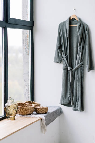 istock Modern spa and bathroom interior concept, relaxing decor. Gray soft bathrobe. Soft selective focus. 1288980170