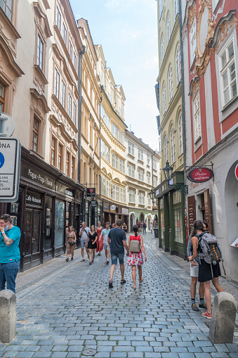 Prague, Czech Republic - July 10, 2020: Husova cobblestone street with tourists in old town of Prague.