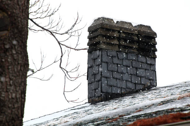 istock chimney on a slate roof during a snowfall 1288981726