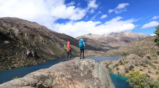 istock Two women backpackers hiking  in beautiful winter mountains 1288982317