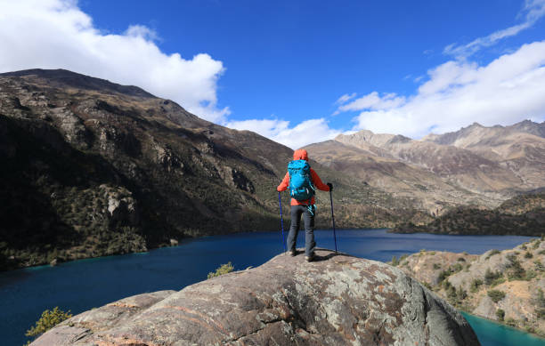 istock Woman backpacker hiking  in beautiful winter mountains 1288982387