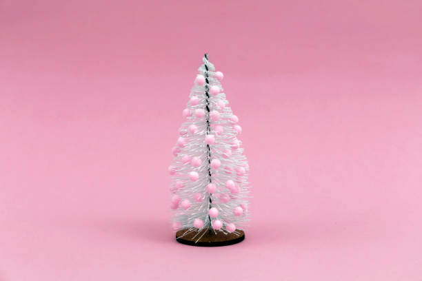 istock Christmas tree with pink decoration on pink background. 1288982468