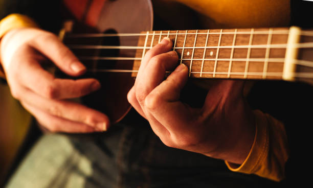 Detail of hand playing the ukulele stock photo