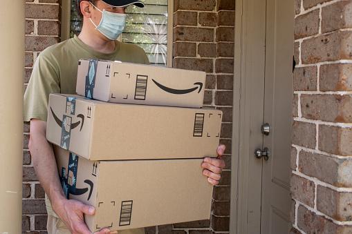 Sydney, Australia - 2020-11-29 Amazon prime boxes delivered to a front door of residential building during the COVID-19 pandemic.