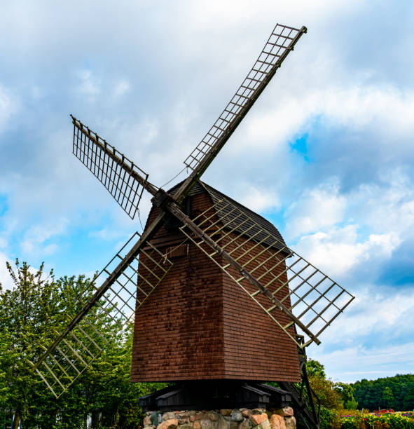 istock Traditional medieval wind mill for milling flour from wheats. 1288985681