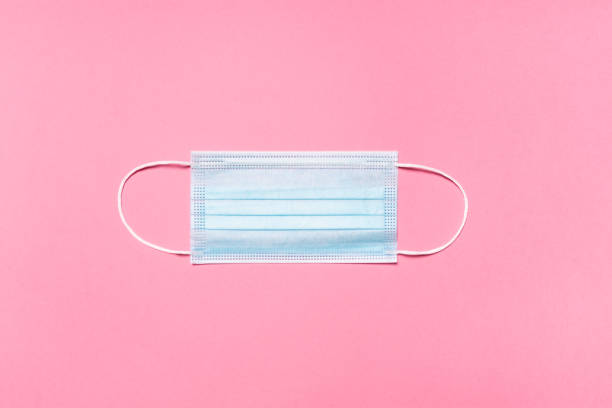 istock Medical mask on pink background 1288985759