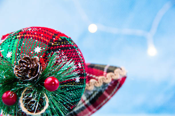 Close-up of a red and green Christmas ornament with small cones on it stock photo