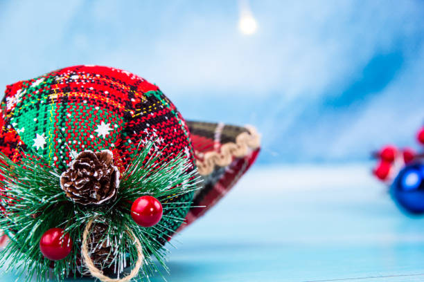 Close-up of a red and green Christmas ornament with small cones on it stock photo
