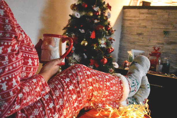 istock Woman relaxing next to a Christmas tree 1288987260