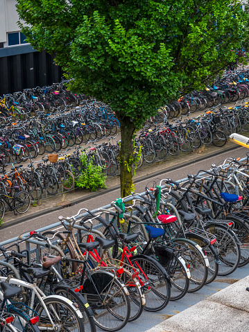 High angle view of Bicycles parked on the side walk right outside of the Central Railway station in downtown Amsterdam.