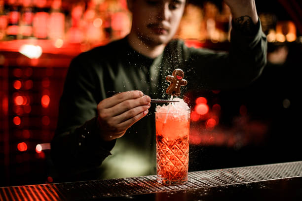 istock view on bartender decorating glass of cold cocktail with chocolate candy and powdered sugar. 1288987509