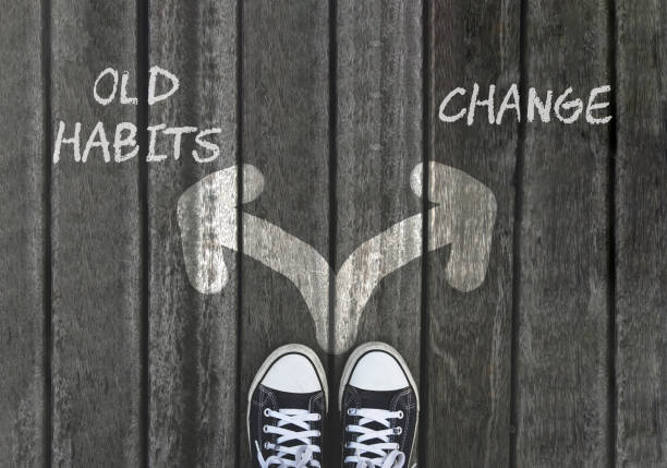 OLD HABITS versus CHANGE written on asphalt road with two white arrows, dilemmas choice concept. Team building, motivation positive thinking OLD HABITS versus CHANGE written on asphalt road with two white arrows, dilemmas choice concept. Team building, motivation positive thinking addiction stock pictures, royalty-free photos & images