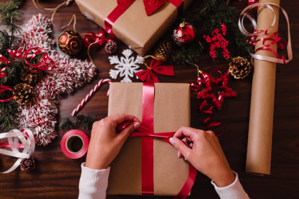 istock Woman wrapping Christmas gifts 1288987749