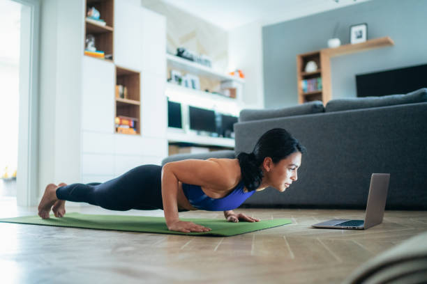 istock Woman working out at home 1288988398