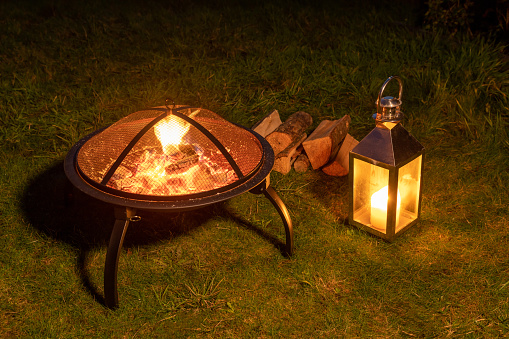 Fire pit in a garden with a lantern