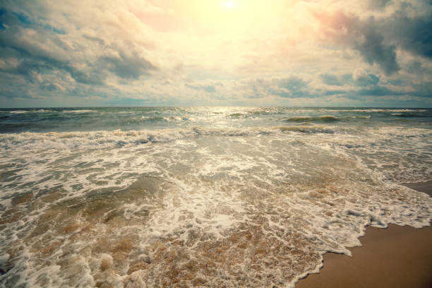 istock Seascape. Seashore at sunset.  Landscape with ocean and bright cloudy sky 1288991200